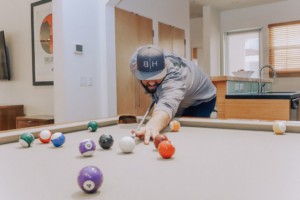 man playing pool in SUD treatment house for men