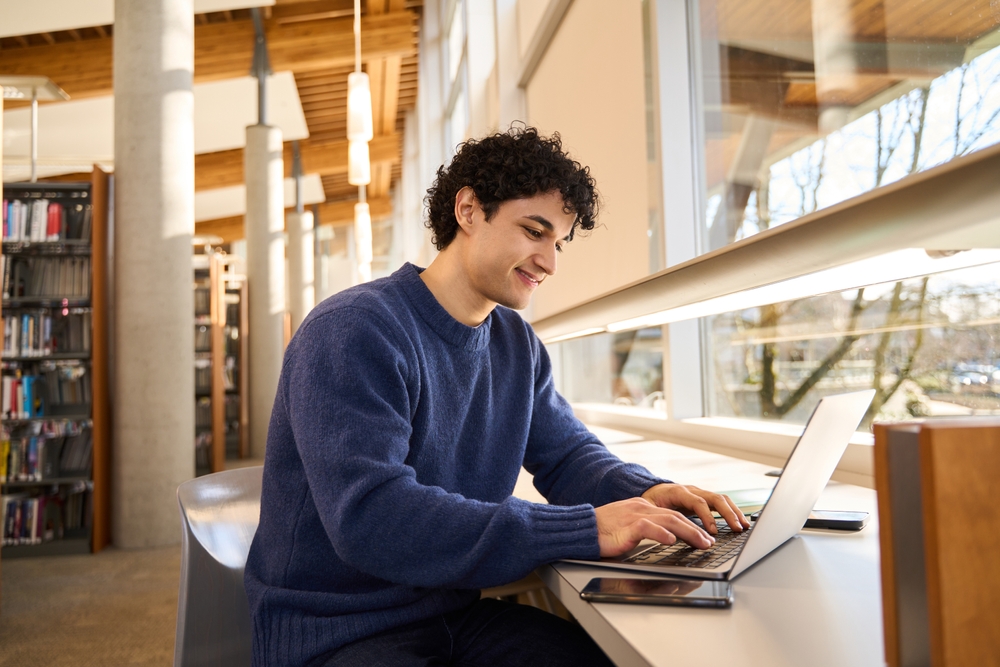 young man on his laptop in residential treatment program for addiction and mental health